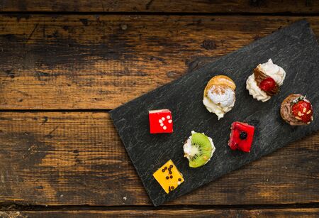 Selection of different dessert pastry sweet mini cakes and tartletsの写真素材