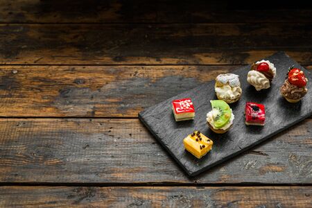 Selection of different dessert pastry sweet mini cakes and tartletsの写真素材