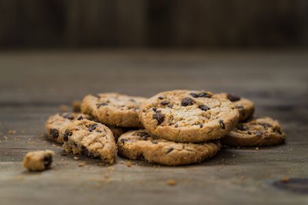 Classic chocolate chip cookies against wooden backgroundの写真素材
