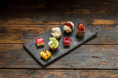 Selection of different dessert pastry sweet mini cakes and tartlets.の写真素材