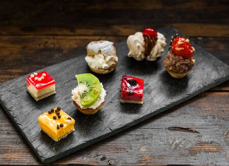 Selection of different dessert pastry sweet mini cakes and tartletsの写真素材