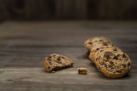 Classic chocolate chip cookies against wooden backgroundの写真素材