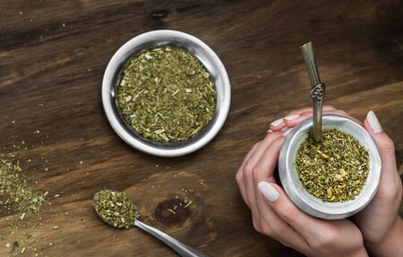 Young woman drinking traditional Argentinian yerba mate teaの写真素材