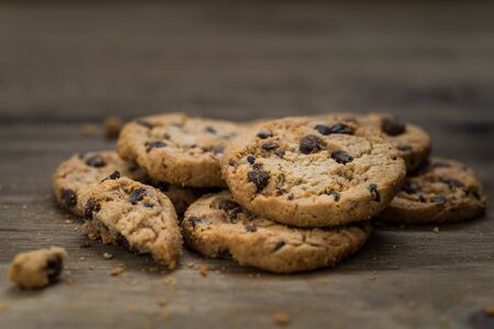 Classic chocolate chip cookies against wooden backgroundの写真素材