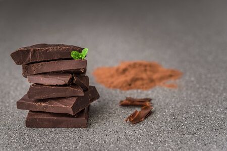 A stack of dark milk chocolate against gray stone backgroundの写真素材