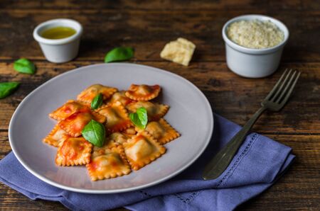Ravioli stuffed pasta with tomato sauce and basilの写真素材
