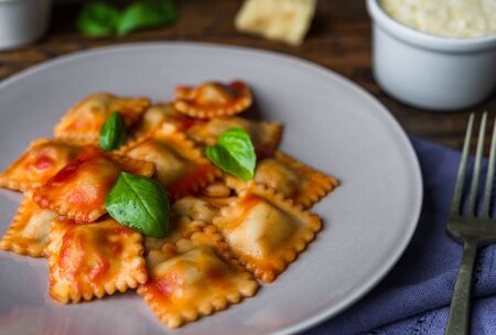 Ravioli stuffed pasta with tomato sauce and basilの写真素材