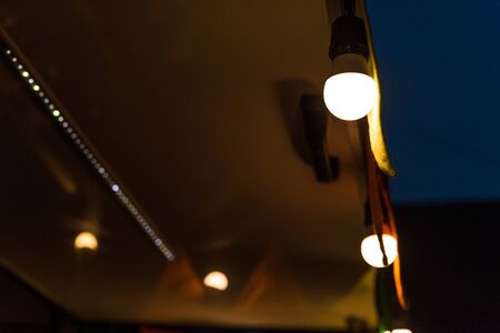 Vintage antique hanging light bulbs at a street food marketの写真素材