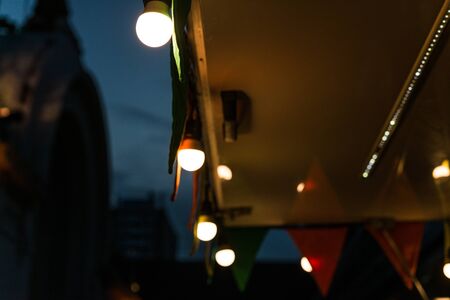 Vintage antique hanging light bulbs at a street food market