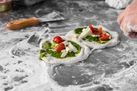 Pizzaiolo chef preparing traditional Italian Neapolitan pizzasの写真素材
