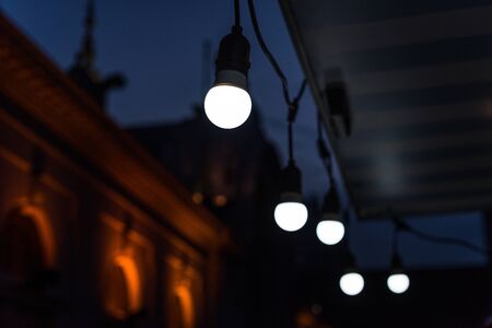 Vintage antique hanging light bulbs at a street food marketの写真素材