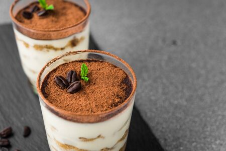 Close up of traditional Italian tiramisu cake sweet dessert on grey backgroundの写真素材