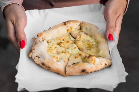 Traditional Italian Neapolitan pizza with lard and cheese at street food marketの写真素材