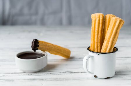 Churros with chocolate, a traditional Spanish sweet food pastry dessert.の写真素材