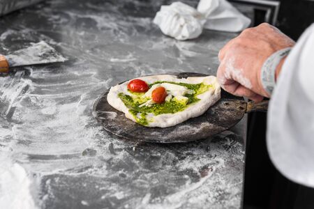 Pizzaiolo chef preparing traditional Italian Neapolitan pizzasの写真素材