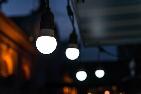 Vintage antique hanging light bulbs at a street food market.の写真素材
