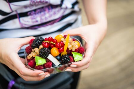 Eating wild berries like raspberry, blueberry, redcurrant, and blackberry.の写真素材