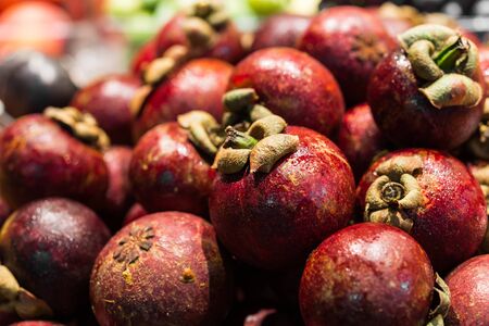 Organic mangosteen exotic fruit at the farmers market stall