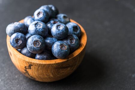 Close up of fresh organic blueberries on black backgroundの写真素材