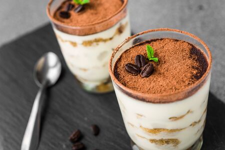 Close up of traditional Italian tiramisu cake sweet dessert on grey background.の写真素材
