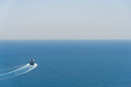 A ferry cruise ship on the background of blue sea and sky with copy spaceの写真素材