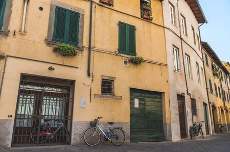 Narrow streets of Lucca ancient town with traditional architecture, Italyの写真素材