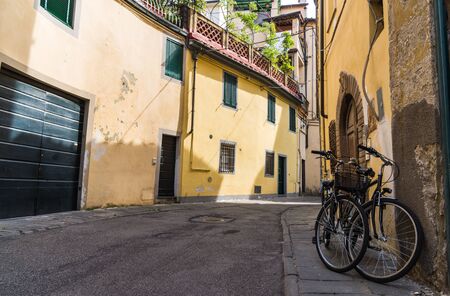 Narrow streets of Lucca ancient town with traditional architecture, Italyの写真素材