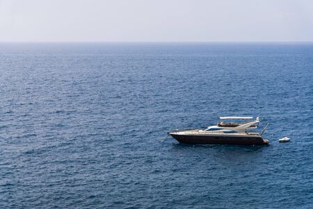 Ligurian Sea coastline in Liguria, Italy, with aquamarine water and boats.の写真素材