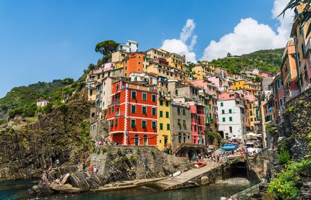 View at Riomaggiore village, Italy, with colorful houses and Ligurian Sea coast.の写真素材