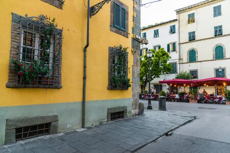 Narrow streets of Lucca ancient town with traditional architecture, Italy.の写真素材