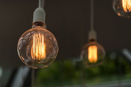 Vintage antique hanging light bulbs. Holidays and business good idea concept.の写真素材