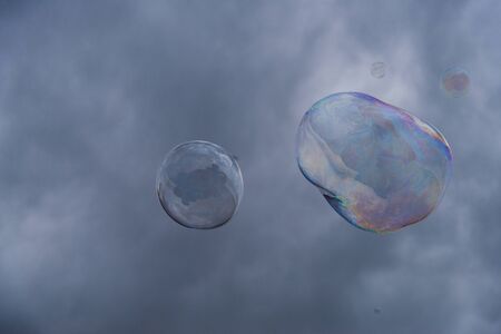 Big soap bubbles against the background of cloudy skyの写真素材