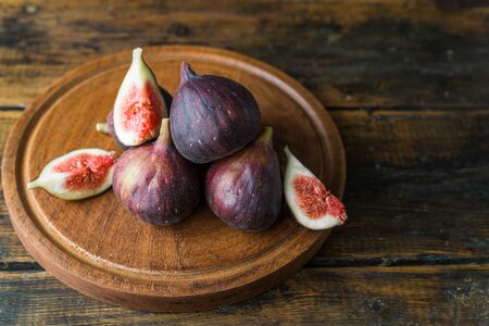 Figs fruit against brown wooden backgroundの写真素材