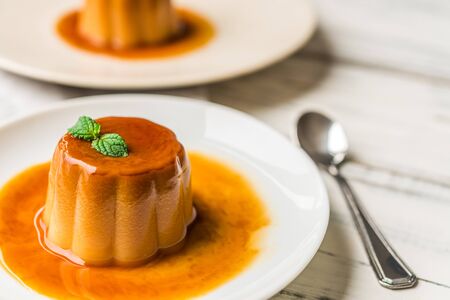 Close up of a flan creme caramel pudding with mint, a custard dessertの写真素材