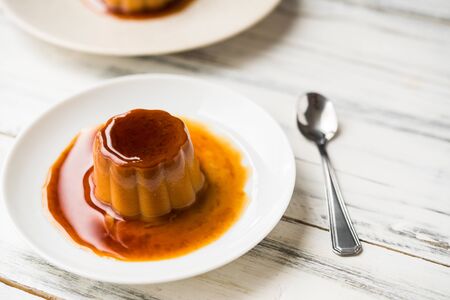 Close up of a flan creme caramel pudding with mint, a custard dessertの写真素材