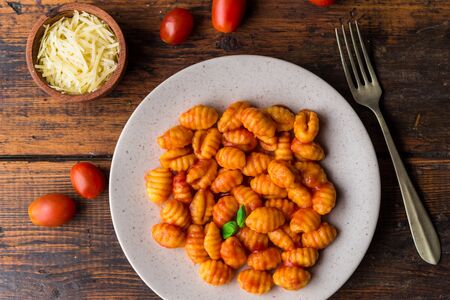 Gnocchi with tomato sauce, basil, and cheese, traditional Italian pasta foodの写真素材