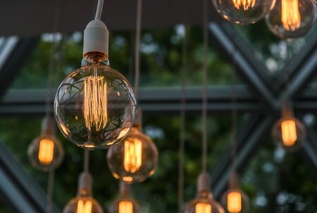 Vintage antique hanging light bulbs. Holidays and business good idea concept.の写真素材
