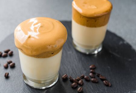 Dalgona coffee whipped cream mousse against grey background.の写真素材