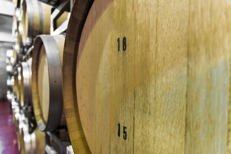 Oak wine barrels for wine fermentation at a winery.
