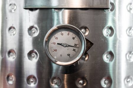 Thermometer on a steel wine tank for wine fermentation at a winery.の写真素材