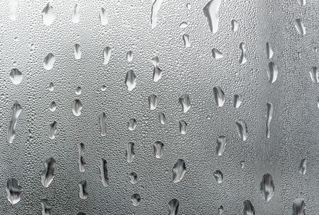 Macro photography water drops on glass window white background after the rain