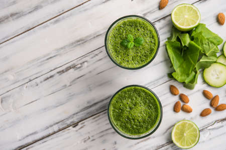 Spinach and almond smoothies against white wooden background.の写真素材