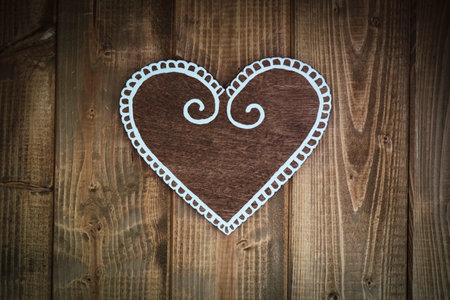 Cute wooden heart on wooden background