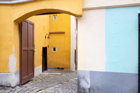 Old yellow and blue walls with wooden doors, ÄeskÃ½ Krumlov, Czech Republicの写真素材