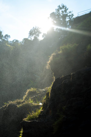 Garden sprinkler watering the grass on the edge of a cliff