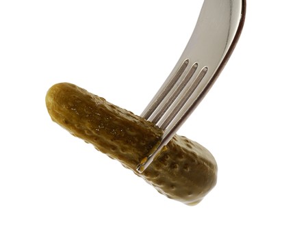 cucumber on the fork, on whiteの写真素材