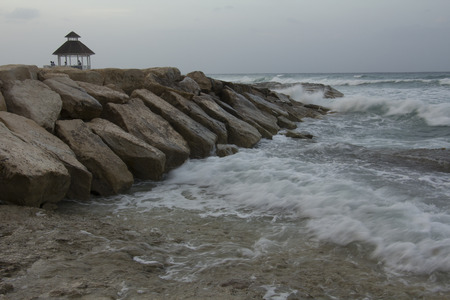 Gazebo on rock by the ocean wtih medium wavesの写真素材