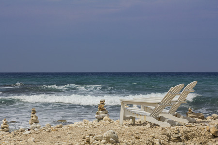 Two deck chair at the beach front oceanの写真素材