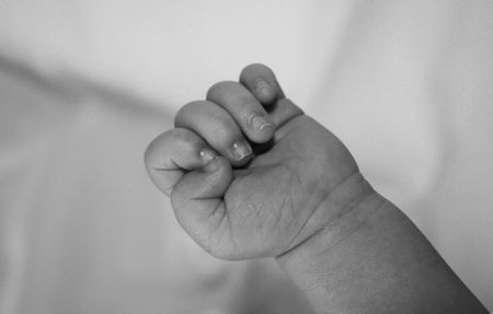 Newborn babys hand in black and whiteの写真素材