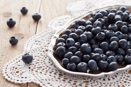 Blueberries on a silver platterの写真素材